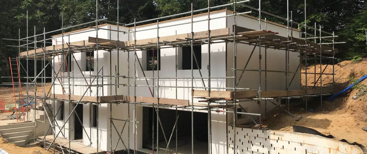 Larger Project Sites Project underway with scaffold on a building under construction that has been externally rendered