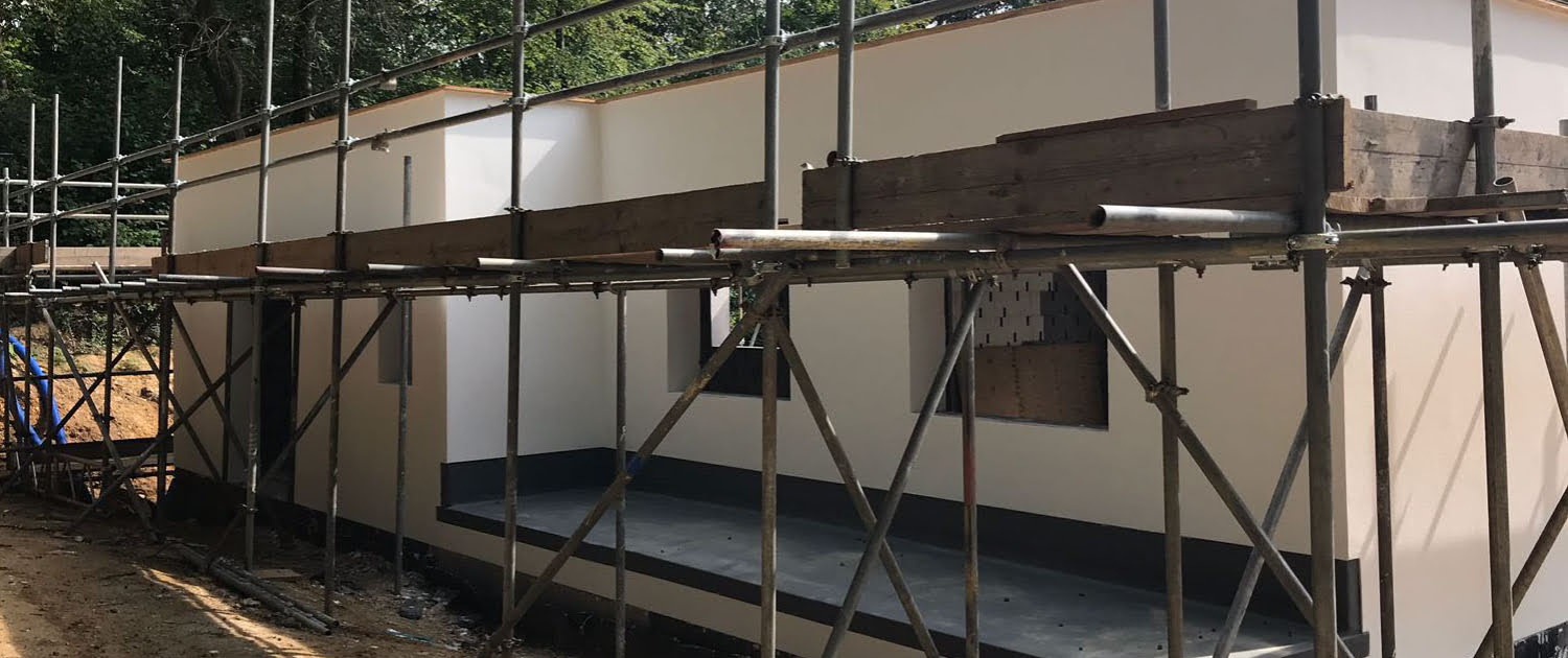 Larger Project Building under construction with scaffold and external silicone render finish applied to the walls