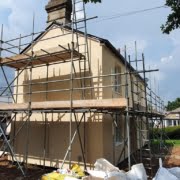 Detached EWI installation in progress with scaffold