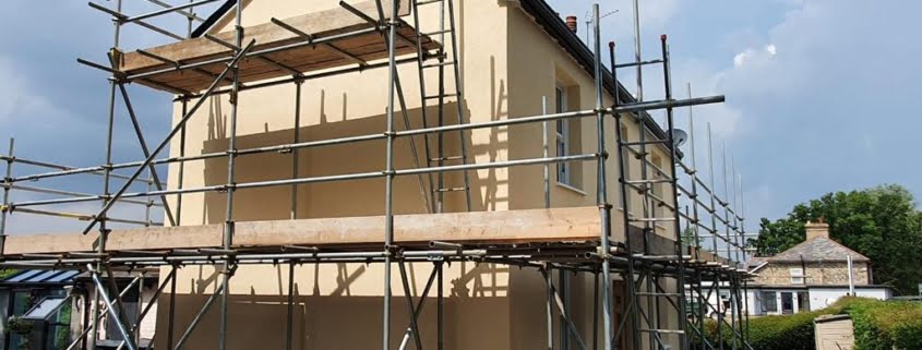 Detached EWI installation in progress with scaffold