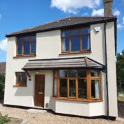 Front view of external wall insulation on a detached house with a bay window April 2022