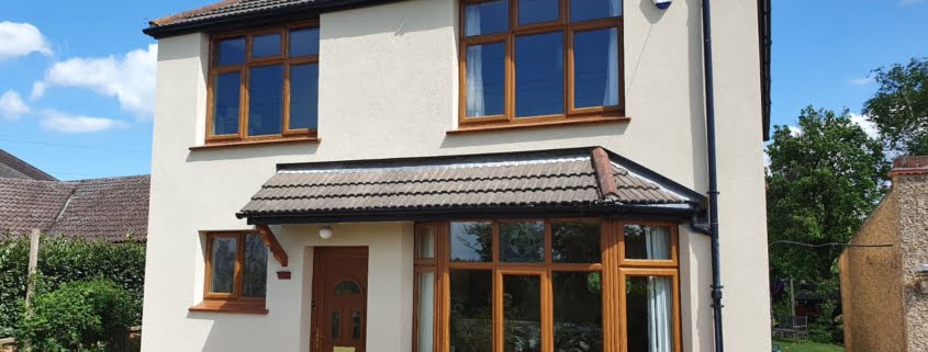 Front view of external wall insulation on a detached house with a bay window April 2022