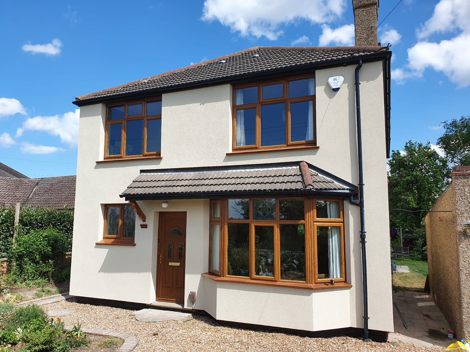 EWI Works April 2022 Front Front view of external wall insulation on a detached house with a bay window April 2022