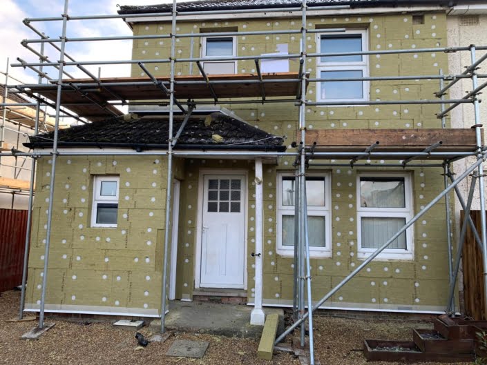 External Wall Insulation boarding and scaffold at the rear of a house